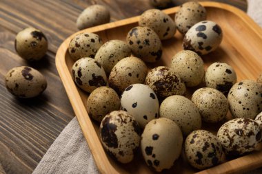 Kahverengi desenli bambu tabaktaki bıldırcın yumurtaları. Organik yiyecekler. Mesaj için yer. taze yumurta