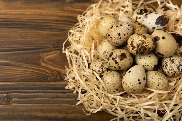 Kahverengi desenli arka planda bıldırcın yumurtası. Organik yiyecek. Mesaj için yer. taze yumurta