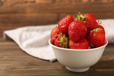 Kahverengi desenli bir kasede taze olgun çilekler. Vejetaryen organik böğürtlen. Sağlıklı yiyecek.