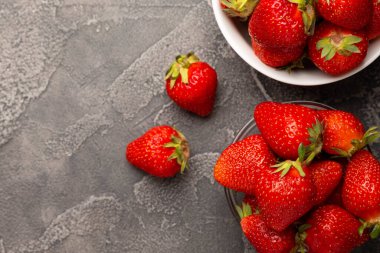 Siyah desenli bir tabakta taze olgun çilekler. Vejetaryen organik böğürtlen. Sağlıklı yiyecek. Vitamin.