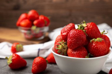 Siyah desenli bir tabakta taze olgun çilekler. Vejetaryen organik böğürtlen. Sağlıklı yiyecek. Vitamin.