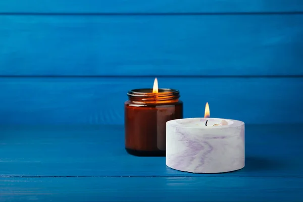 Cozy Burning Candle Brown Glass Jar Concrete Planter Blue Wood — ストック写真