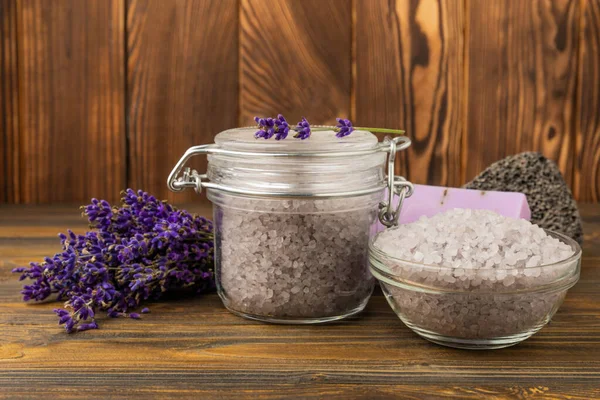 Lavender spa. Sea salt, lavender flowers and handmade soap. Natural herbal cosmetics with lavender flowers on brown texture wood.Spa and relaxation concept.Beauty treatments.Copy space.