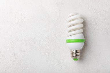 LED lamp energy efficiency concept. Composition on white cement background. Use economical and environmentally friendly light bulb concept.Eco. flat lay.copy space.MOCKUP