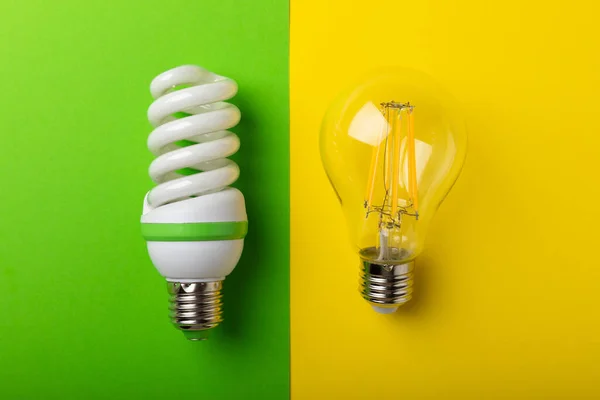 Electric light bulbs. the concept of energy efficiency. LED lamp vs incandescent lamp. Composition on a yellow-green background. Use an economical and environmentally friendly light bulb concept.