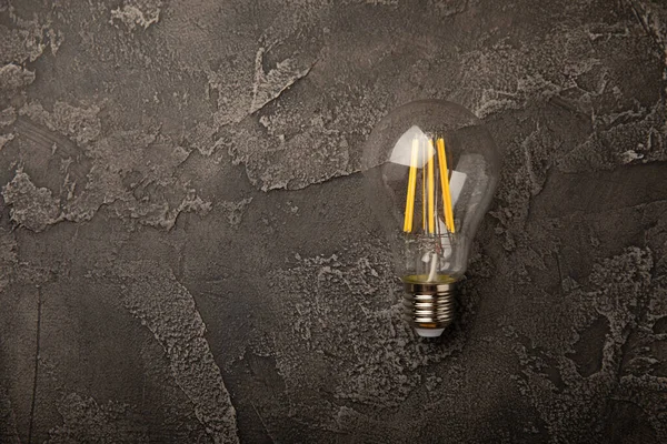 Electric light bulbs. the concept of energy efficiency. Composition on a black marble background. Use an economical and environmentally friendly light bulb concept.