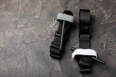 Medical tourniquet to stop the blood on a black textured background. Place to copy. flat laying.