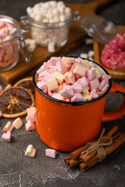 Cocoa drink on texture background. Hot chocolate with small marshmallows and spices. Winter warming drink concept. Space for copy. Space for text