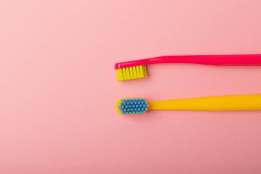 Oral care. Toothbrushes on a pink background. The concept of cosmetic products for the bathroom. Flat lay, copy space. A set of oral care products. Oral hygiene