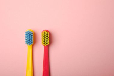 Oral care. Toothbrushes on a pink background. The concept of cosmetic products for the bathroom. Flat lay, copy space. A set of oral care products. Oral hygiene