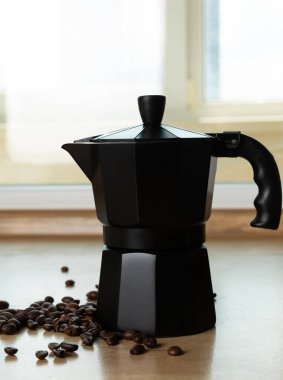 Metal coffee maker in the kitchen. Geyser coffee maker with coffee beans.Concept morning.Morning coffee. Place to copy. Place for text.