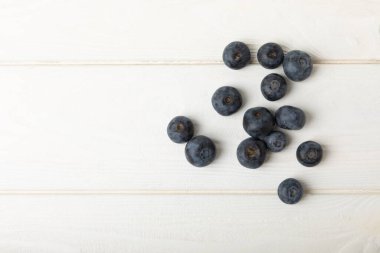 Blueberries on white textured background. Ripe and fresh blueberries. Vitamins. Healthy food. Juicy berry.Copy space.Place for text