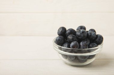 Blueberries in a bowl on white textured background. Ripe and fresh blueberries. Vitamins. Healthy food. Juicy berry.Copy space.Place for text