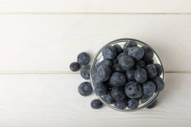 Blueberries in a bowl on white textured background. Ripe and fresh blueberries. Vitamins. Healthy food. Juicy berry.Copy space.Place for text