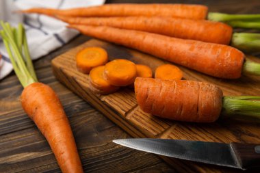 Slice carrot.Fresh carrots on brown texture background. Ingredient for salad.Vegetarian organic vegetables.Healthy food.Copy space.Place for text