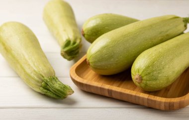 Squash vegetable marrow zucchini on white texture background.Vegetarian organic vegetables.Healthy food.Copy space.Place for text.Healthy food concept.