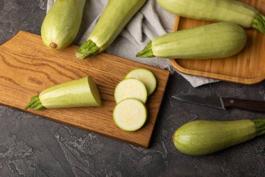 Zucchini slices.Squash vegetable marrow zucchini on black texture background.Vegetarian organic vegetables.Healthy food.Copy space.Place for text.Healthy food concept.
