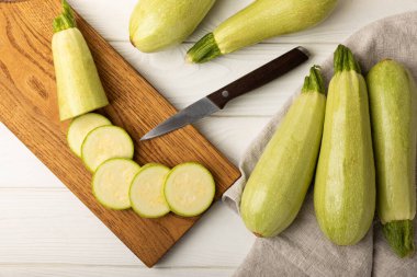 Slices of zucchini.Squash vegetable marrow zucchini on white texture background.Vegetarian organic vegetables.Healthy food.Copy space.Place for text.Healthy food concept.