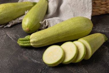 Zucchini slices.Squash vegetable marrow zucchini on black texture background.Vegetarian organic vegetables.Healthy food.Copy space.Place for text.Healthy food concept.