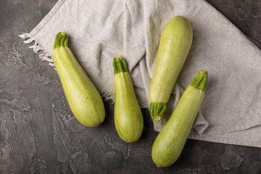 Squash vegetable marrow zucchini with kitchen towel on black texture background.Vegetarian organic vegetables.Healthy food.Copy space.Place for text.Healthy food concept.
