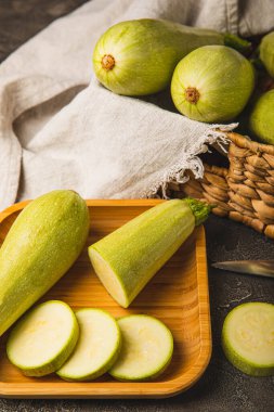 Zucchini slices.Squash vegetable marrow zucchini on black texture background.Vegetarian organic vegetables.Healthy food.Copy space.Place for text.Healthy food concept.