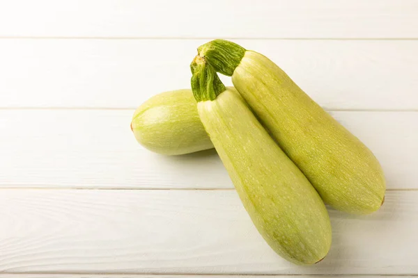 Squash vegetable marrow zucchini on white texture background.Vegetarian organic vegetables.Healthy food.Copy space.Place for text.Healthy food concept.