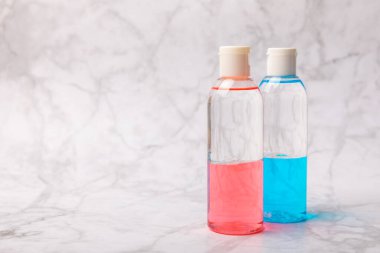 Face care for the face, tonic or lotion, micellar water on a marble background.Beauty concept.Freshness and naturalness Anti-aging care. Women's daily fresh cosmetics. Copy space. Flat lay.