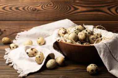 Quail eggs on brown texture table background. Whole and broken quail eggs. natural products. Place for text. Fresh quail eggs.
