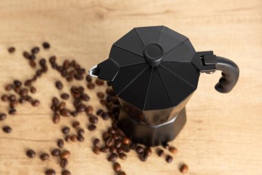 Geyser coffee maker with coffee beans on a light background. Kettle for making coffee. The concept of making aromatic coffee. Good morning . Place for text. copy space.