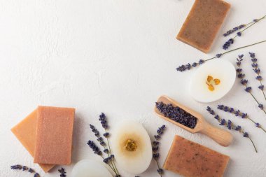 Natural soap with lavender extract. Handmade soap with lavender flowers on a white texture background. spa and relaxation concept.Aromatherapy.Flat lay.Place for text.Place for copy.