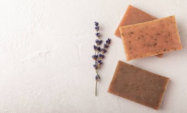 Natural soap with lavender extract. Handmade soap with lavender flowers on a white texture background. spa and relaxation concept.Aromatherapy.Flat lay.Place for text.Place for copy.