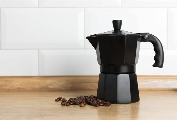 Geyser coffee maker with coffee beans on a light background. Kettle for making coffee. The concept of making aromatic coffee. Good morning . Place for text. copy space.