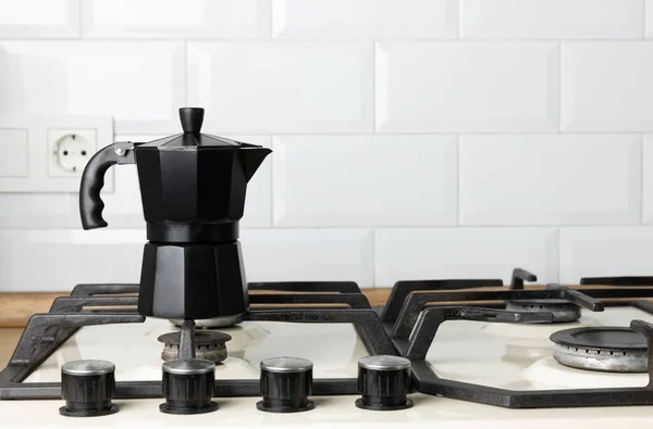 Metal coffee maker in the kitchen. Geyser coffee maker on a gas stove. Morning concept. Morning coffee. Preparing coffee.Copy space. Place for text.