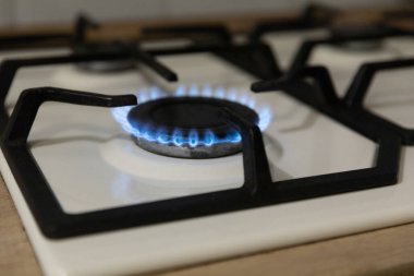 Close-up of a blue flame of fire from a home cooking stove. The concept of industrial resources and economy. Gas stove with a burning flame.Propane.Close-up.Copy space.