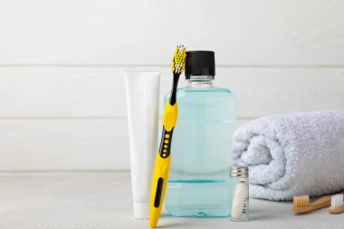 Toothbrush and mouthwash on white background with copy space. Flat lay. Oral hygiene. Oral Care Kit. Dentist concept.