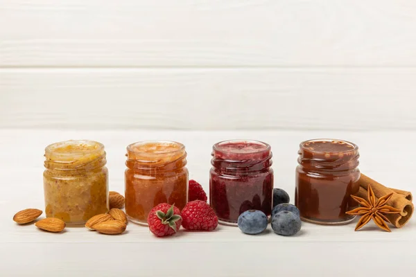 Jar of honey. Fruit honey with raspberries, blueberries, almonds and pistachios. Useful fortified beekeeping product for health and beauty. Honey cream. Vegetarian diet organic product. Copy space. place for text
