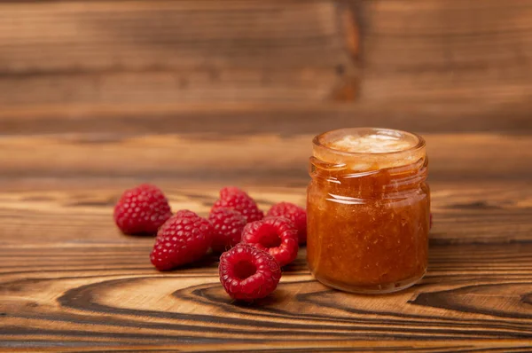 Jar of honey. Raspberry honey.Cold remedy.Useful fortified beekeeping product for health and beauty.Cream honey.Vegetarian diet organic product.Copy space. place for text