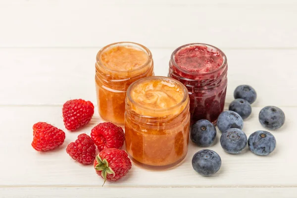 Jar of honey. Fruit honey with raspberries, blueberries, almonds and pistachios. Useful fortified jam for health and beauty. Honey cream. Vegetarian diet organic product. Copy space.