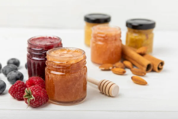 Jar of honey. Fruit honey with raspberries, blueberries, almonds and pistachios. Useful fortified jam for health and beauty. Honey cream. Vegetarian diet organic product. Copy space.