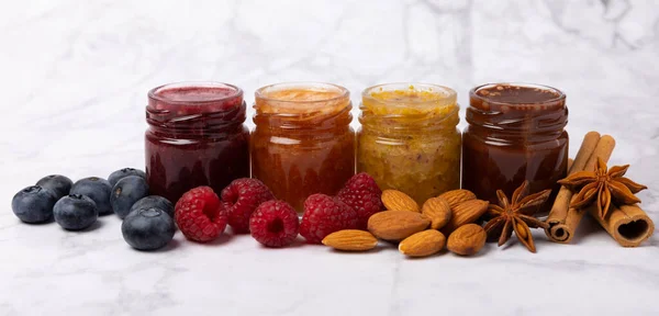 Jar of honey. Fruit honey with raspberries, blueberries, almonds and pistachios. Jams for health and beauty. Honey cream. Organic product of a vegetarian diet. Copy space.Copy space.