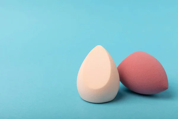 Beauty blender.Colorful beauty sponges on blue background. Cosmetic tool for applying and blending products such as foundation and concealer. Copy space. place for text.