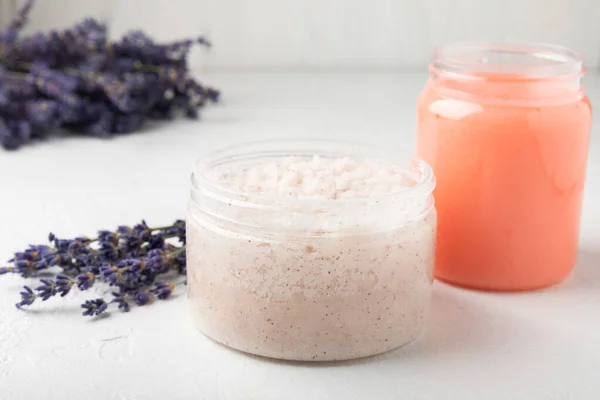Natural lavender scrub on a white texture background.Body scrub. Body care. Sugar peeling scrub with argan oil and Himalayan salt. spa set