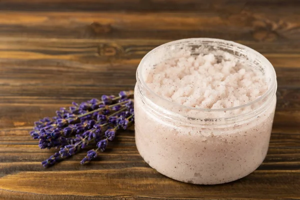 Natural lavender scrub on a brown texture background.Body scrub. Body care. Sugar peeling scrub with argan oil and Himalayan salt. spa set