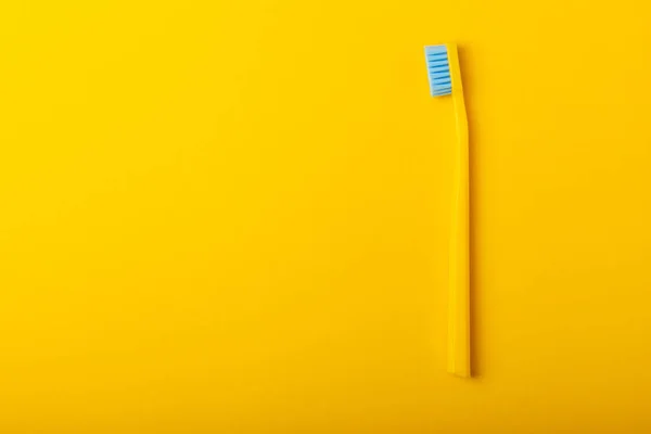 Toothbrushes. Oral care. Dental care. Composition with bright toothbrushes on a yellow background.Professional dental care. Copy space. Place for text.Fletley