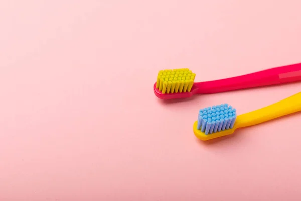 Toothbrushes. Oral care. Dental care. Composition with bright toothbrushes on a pink background.Professional dental care. Copy space. Place for text.Fletley