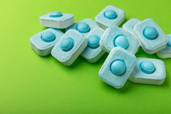 Water softener tablets on green background.FLAT LAY. Place for text.Space for copy.Top view. Close-up