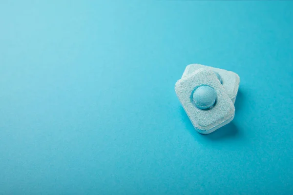 Water softener tablets on a blue background.FLAT LAY. Place for text.Space for copy.Top view. Close-up