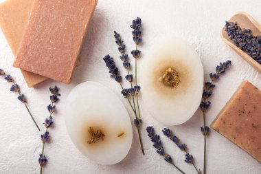 Natural soap with lavender extract. Handmade soap with lavender flowers on a white texture background. spa and relaxation concept.Aromatherapy.Flat lay.Place for text.Place for copy.
