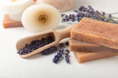 Natural soap with lavender extract. Handmade soap with lavender flowers on a white texture background. spa and relaxation concept.Aromatherapy.Flat lay.Place for text.Place for copy.