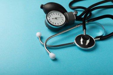 Gray tonometer on a blue background. Medical equipment blood pressure monitor. Healthcare. Place for text. Medicine concept. The concept of cardiology.